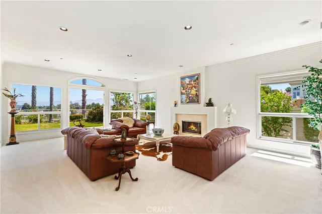 a living room with furniture large window and a fireplace