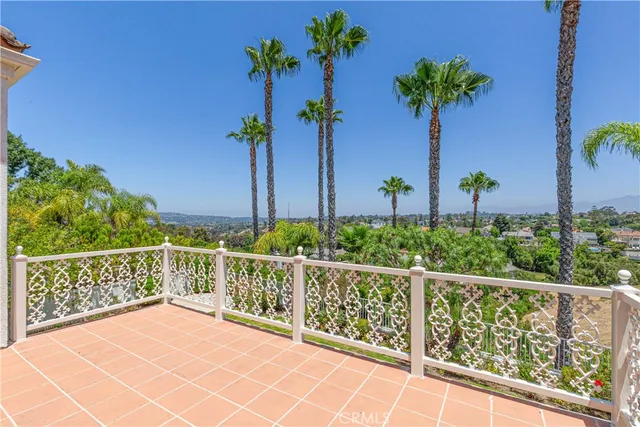 a view of a balcony with flower plants