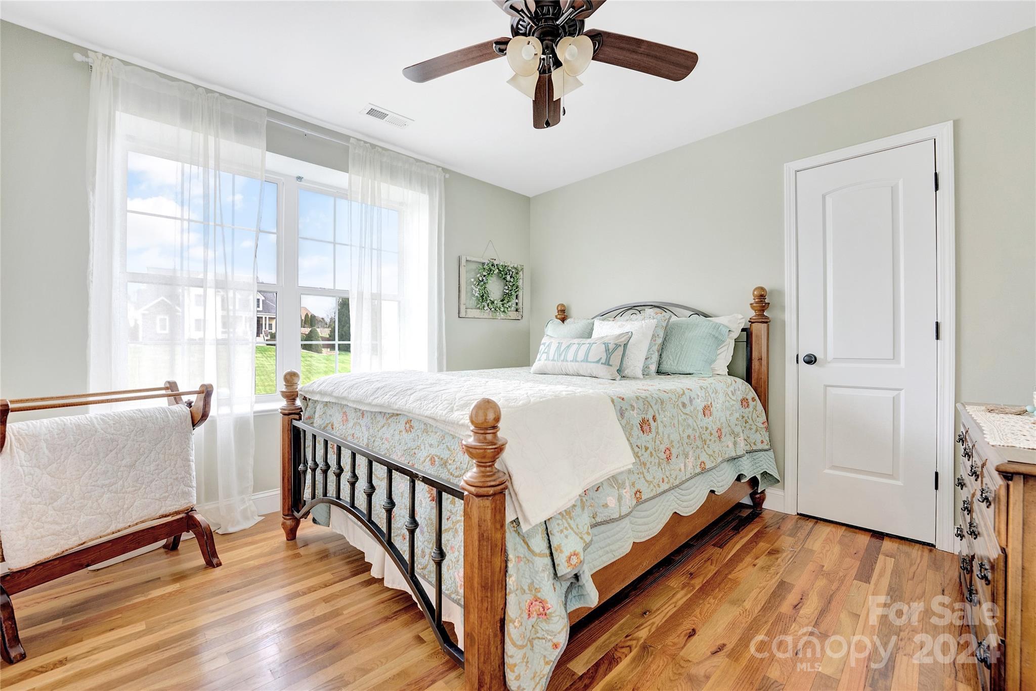 29 Willow Bend Candler, NC 28715 - Photo 34 of 45 a bedroom with a bed and a chandelier