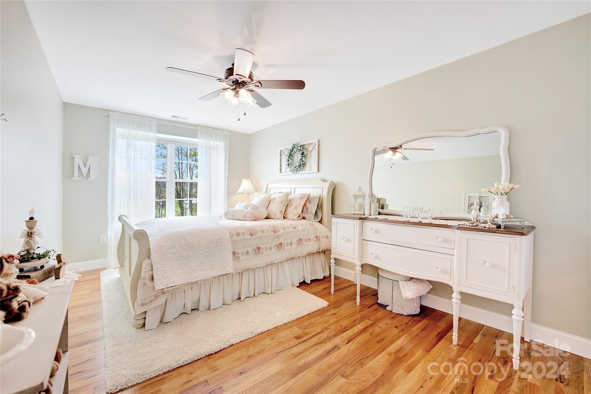 29 Willow Bend Candler, NC 28715 - Photo 35 of 45 a bedroom with a bed and a chandelier