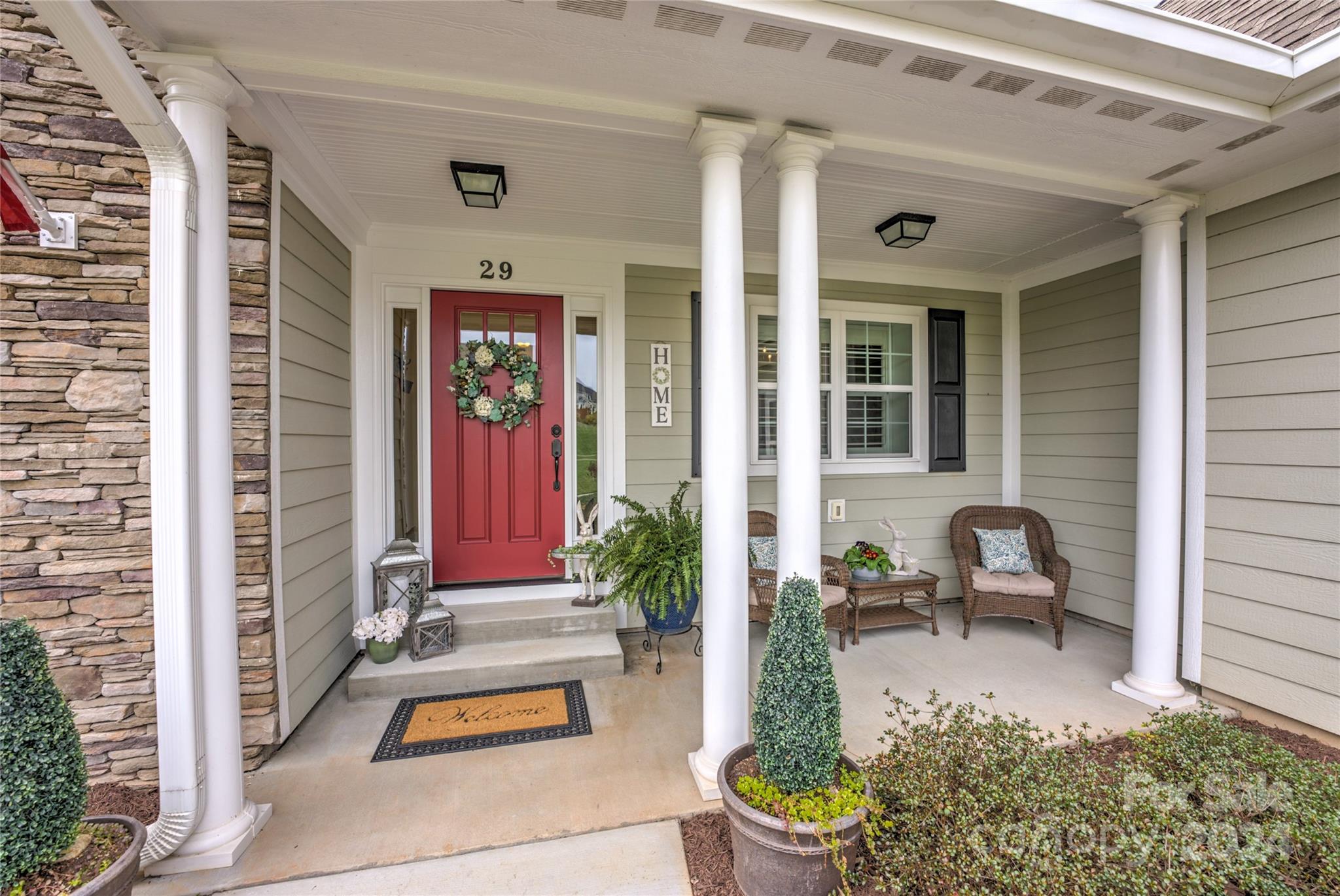 29 Willow Bend Candler, NC 28715 - Photo 4 of 45 a front view of a house with outdoor seating and a potted plant