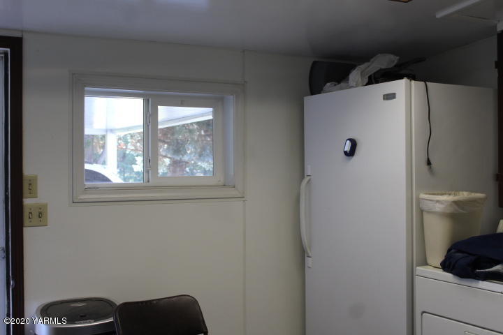 2422 Blaine Road Zillah, WA 98953 - Photo 13 of 39 a white refrigerator freezer sitting inside of a kitchen