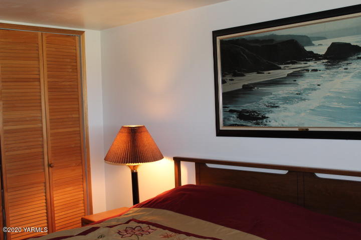 2422 Blaine Road Zillah, WA 98953 - Photo 21 of 39 a bedroom with a bed and a painting on the wall