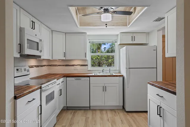 a kitchen with stainless steel appliances granite countertop a refrigerator sink and cabinets
