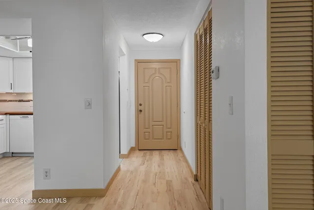 a view of a hallway with wooden floor