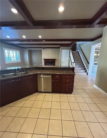 a view of an empty room with wooden floor and windows
