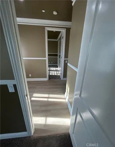 a view of an empty room with a window and fireplace