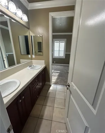 a bathroom with a tub a sink and a large mirror
