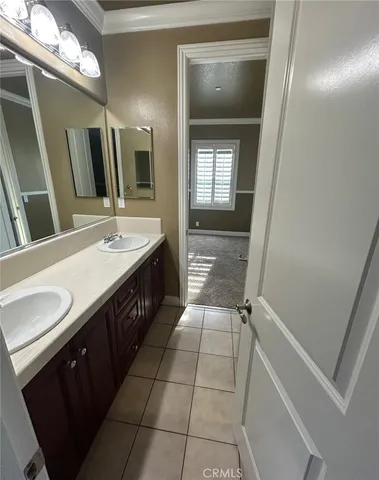 a bathroom with a tub a sink and a large mirror