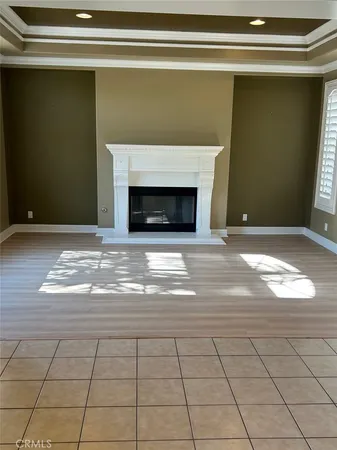 a view of empty room with window and fireplace