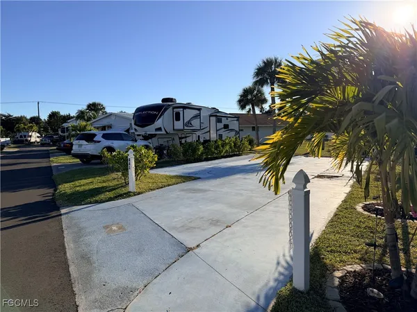 a view of a park with iron fence