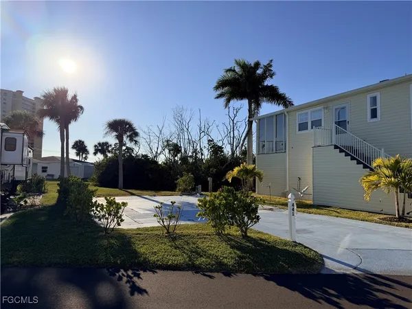 a front view of a house with a yard and a garden
