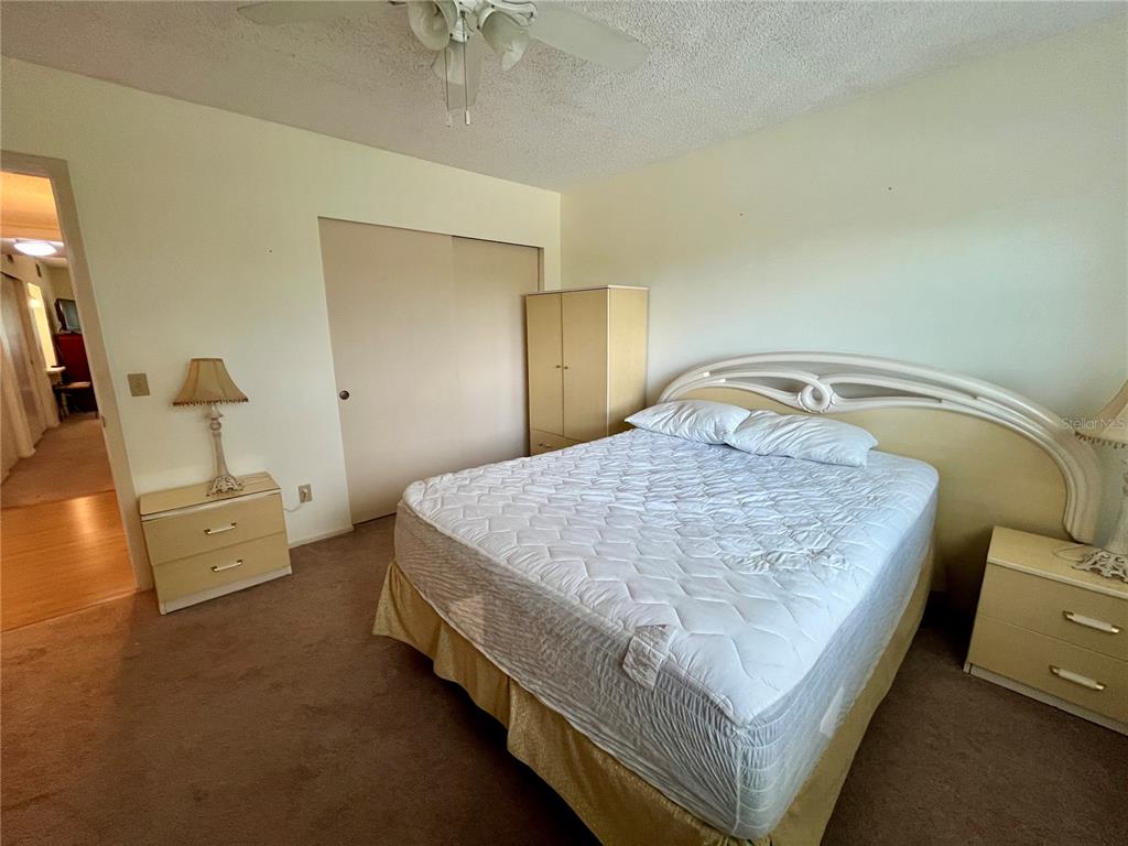 2292 Costa Rican Drive, Unit 22 Clearwater, FL 33763 - Photo 23 of 44 a bed sitting in a bedroom next to a larger window