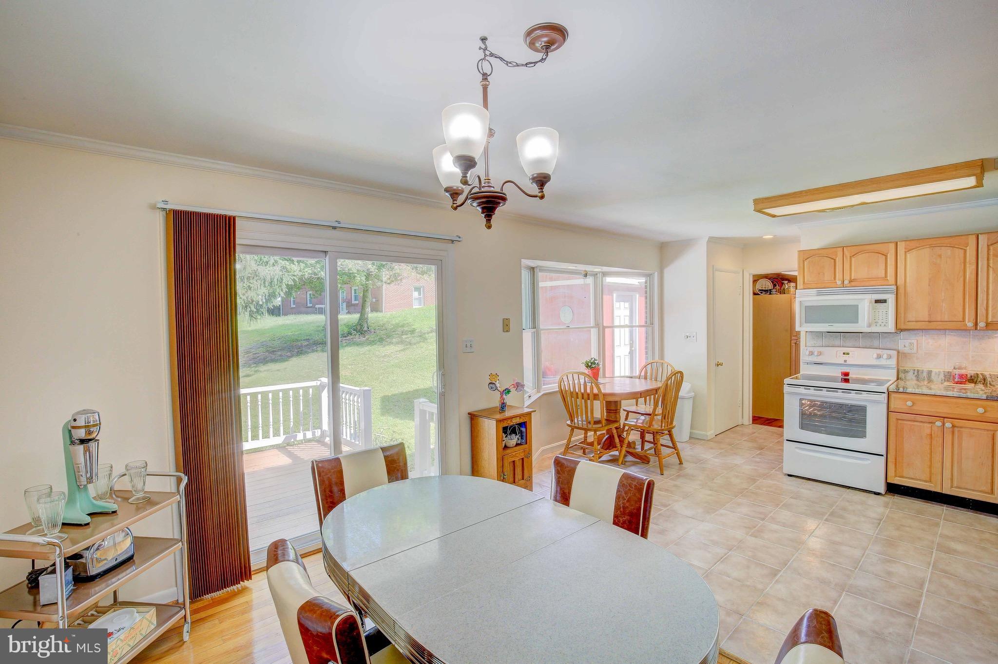 147 Calvert Towne Road Prince Frederick, MD 20678 - Photo 11 of 30 a dining room with furniture a chandelier and wooden floor