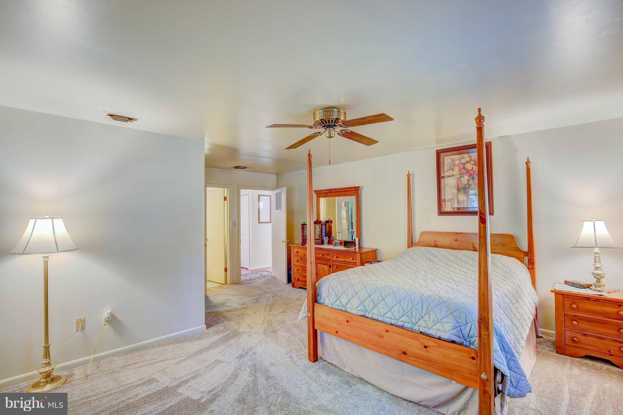 147 Calvert Towne Road Prince Frederick, MD 20678 - Photo 16 of 30 a bedroom with a bed and wooden floor