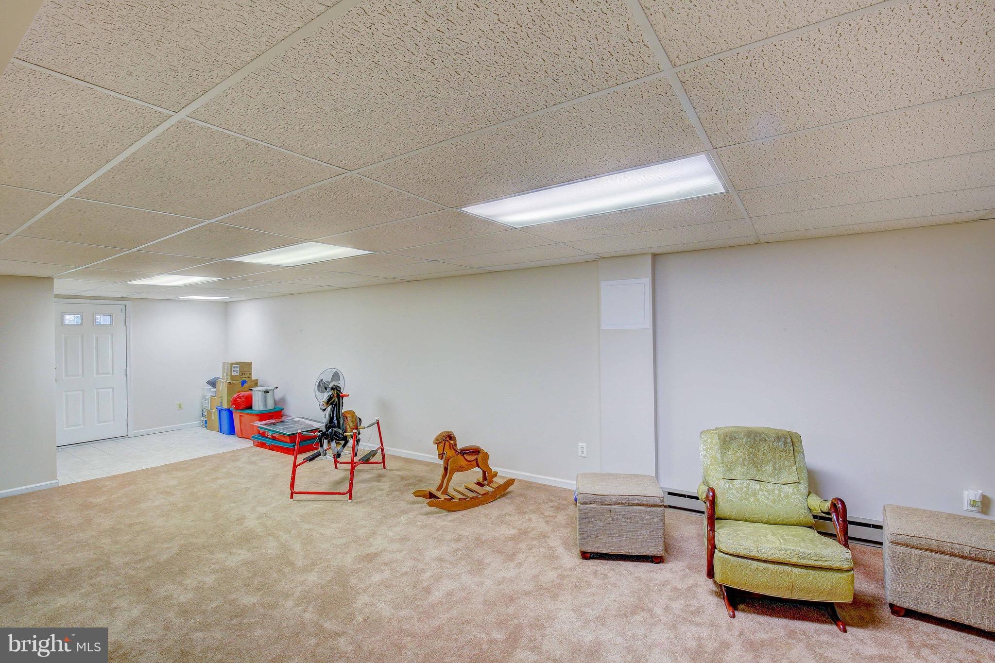 147 Calvert Towne Road Prince Frederick, MD 20678 - Photo 18 of 30 a living room with furniture and a gym machine