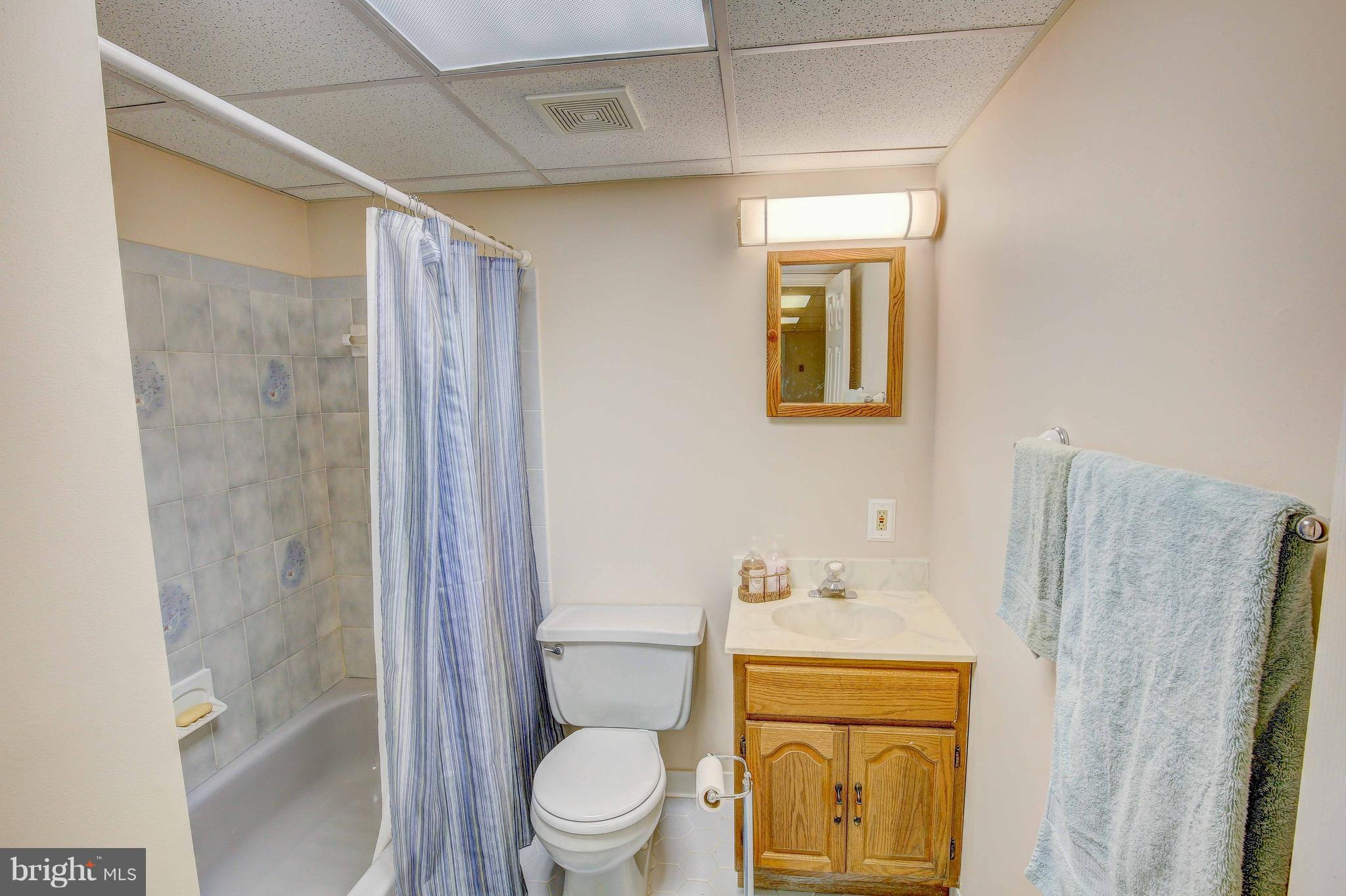 147 Calvert Towne Road Prince Frederick, MD 20678 - Photo 22 of 30 a bathroom with a toilet sink vanity and mirror