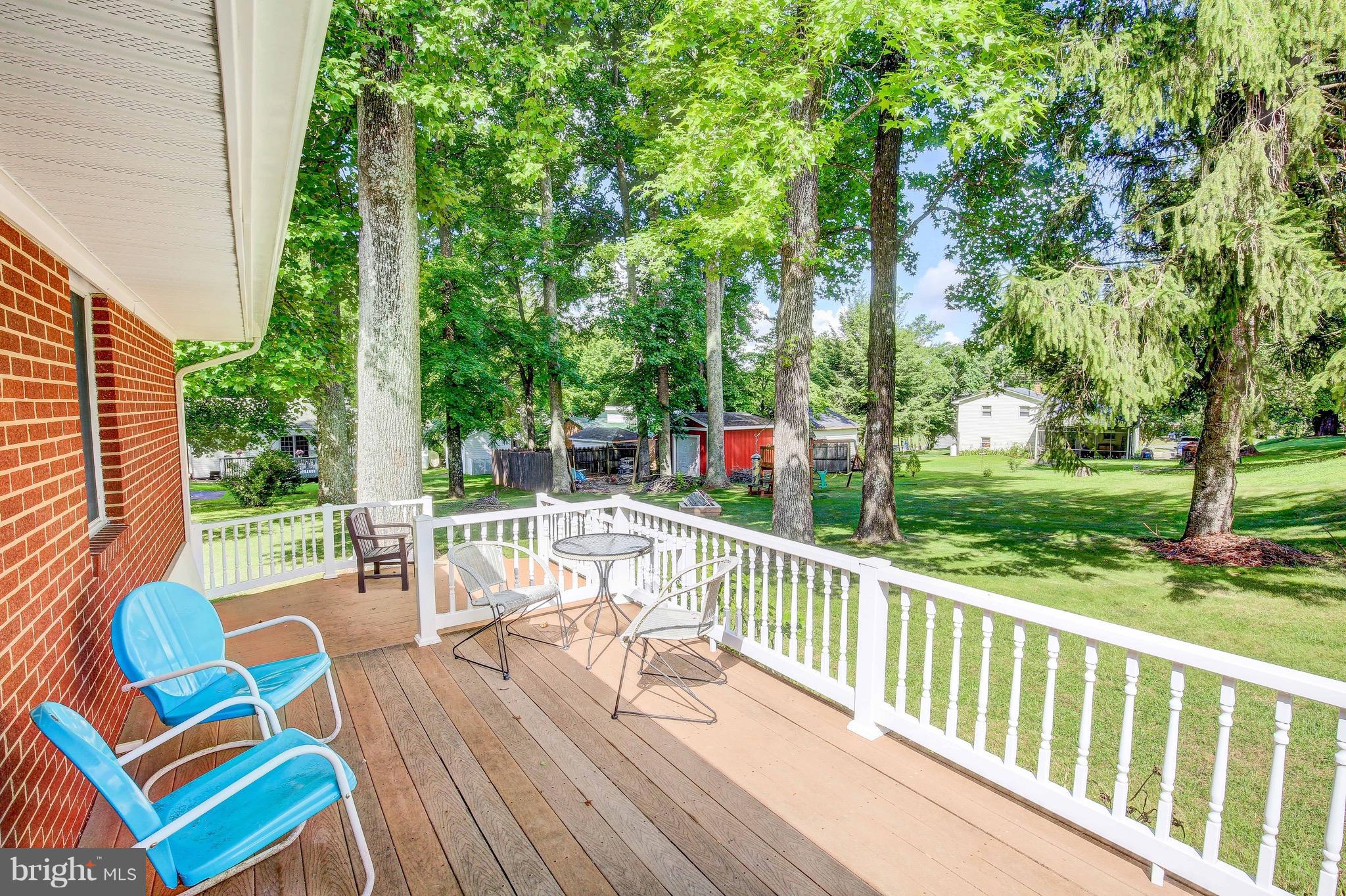 147 Calvert Towne Road Prince Frederick, MD 20678 - Photo 4 of 30 a view of a patio with a table chairs and a backyard