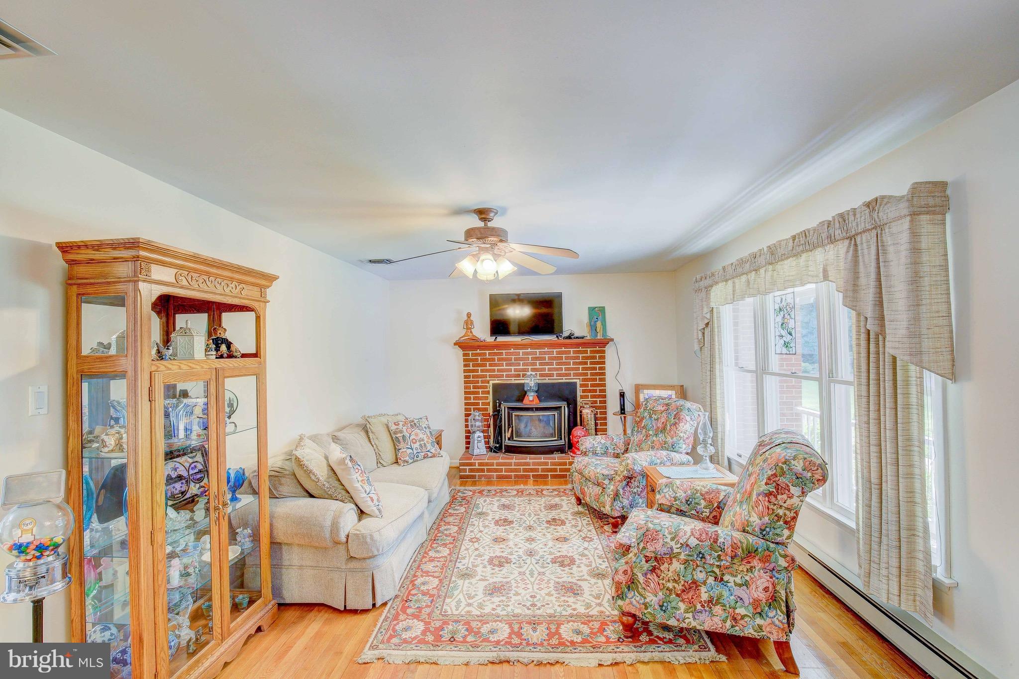 147 Calvert Towne Road Prince Frederick, MD 20678 - Photo 6 of 30 a living room with furniture large window and fireplace