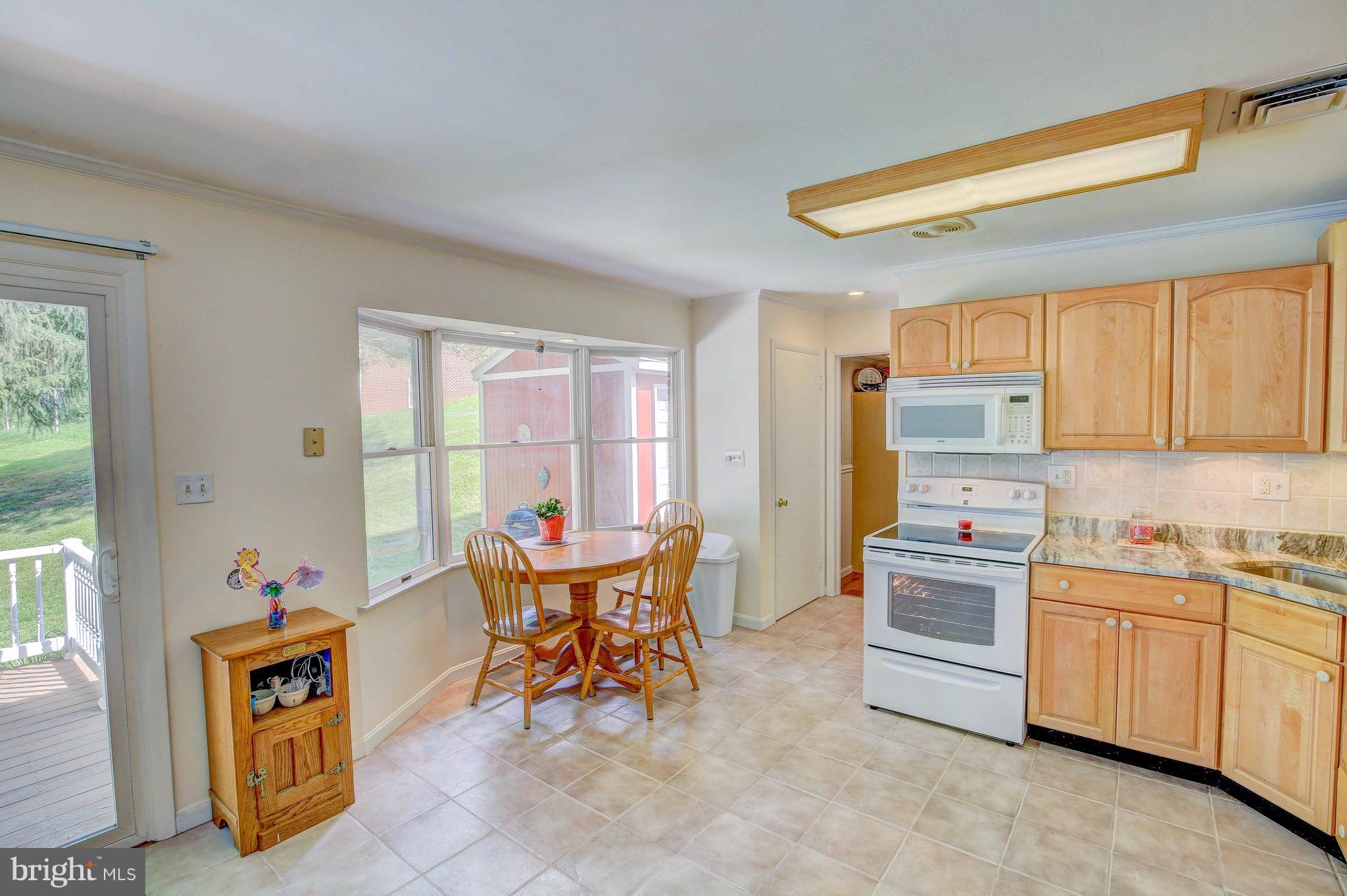 147 Calvert Towne Road Prince Frederick, MD 20678 - Photo 10 of 30 a view of a dining room with furniture and windows