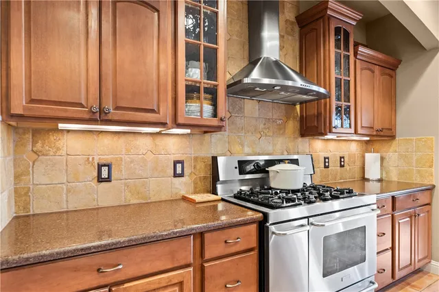 a kitchen with stainless steel appliances granite countertop a sink and cabinets