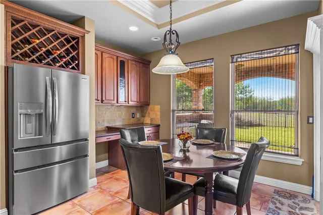 a dining room with furniture a chandelier and window