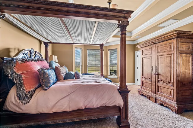 a bedroom with a bed and large window