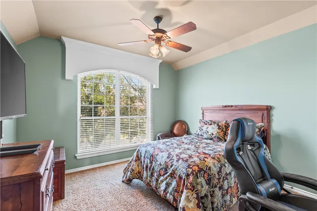 a bed sitting in a bedroom next to a window