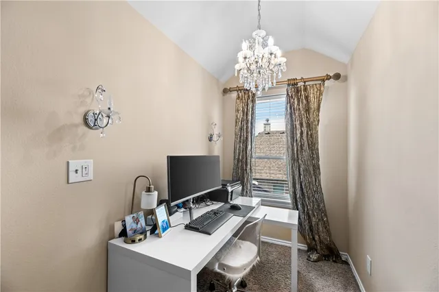 a very nice looking room with a large bed and a chandelier