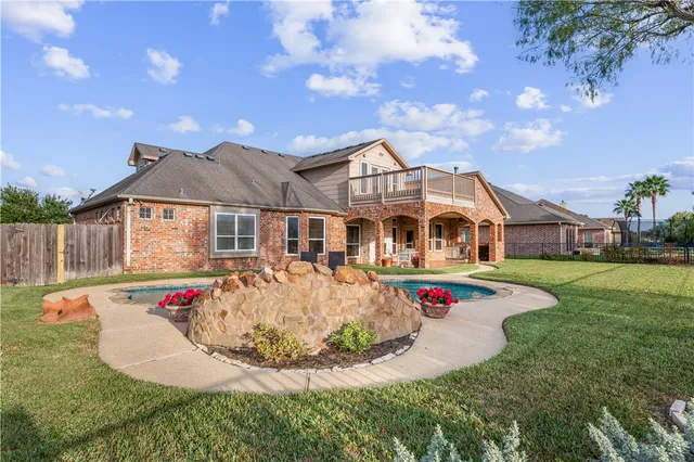 a front view of a house with swimming pool and porch