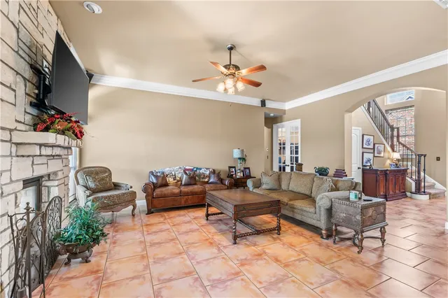 a living room with furniture and a chandelier