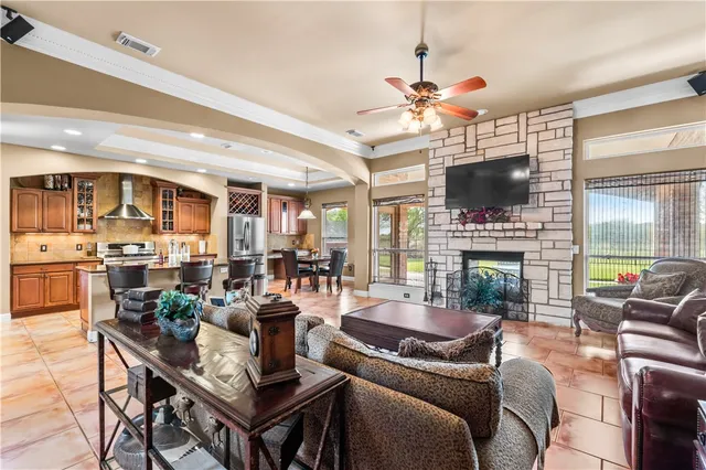 a living room with fireplace furniture a flat screen tv and a fireplace