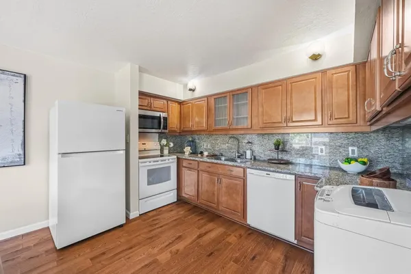 a kitchen with stainless steel appliances granite countertop a refrigerator sink and cabinets