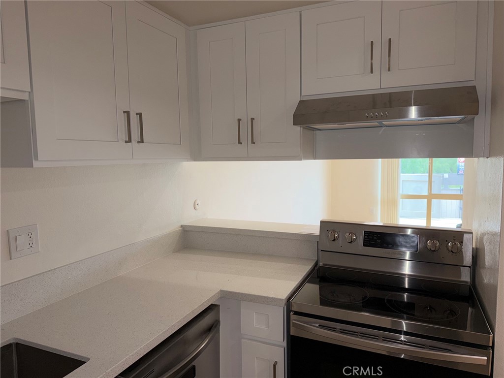 3054 Associated, Unit 26 Fullerton, CA 92835 - Photo 4 of 27 a kitchen with a sink and cabinets
