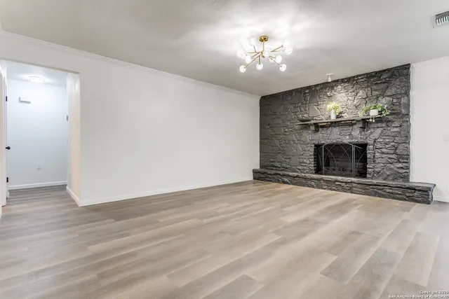 a view of an empty room with a fireplace