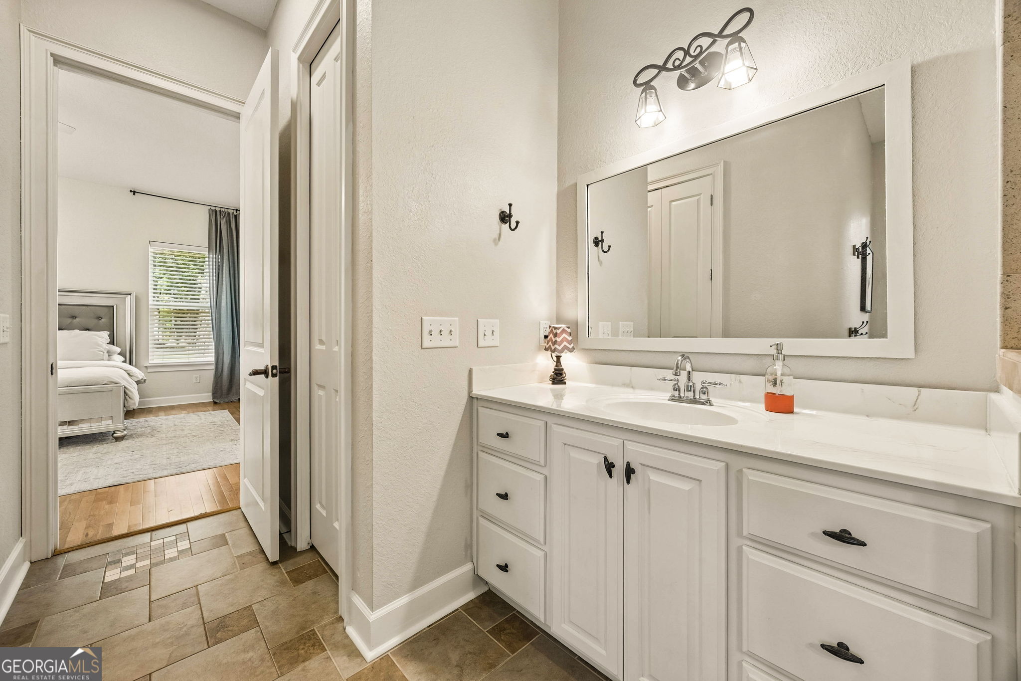 706 Hopewell Point Road White Oak, GA 31568 - Photo 37 of 84 A spacious vanity with abundant storage and quartz-style countertops provides both beauty and functionality.