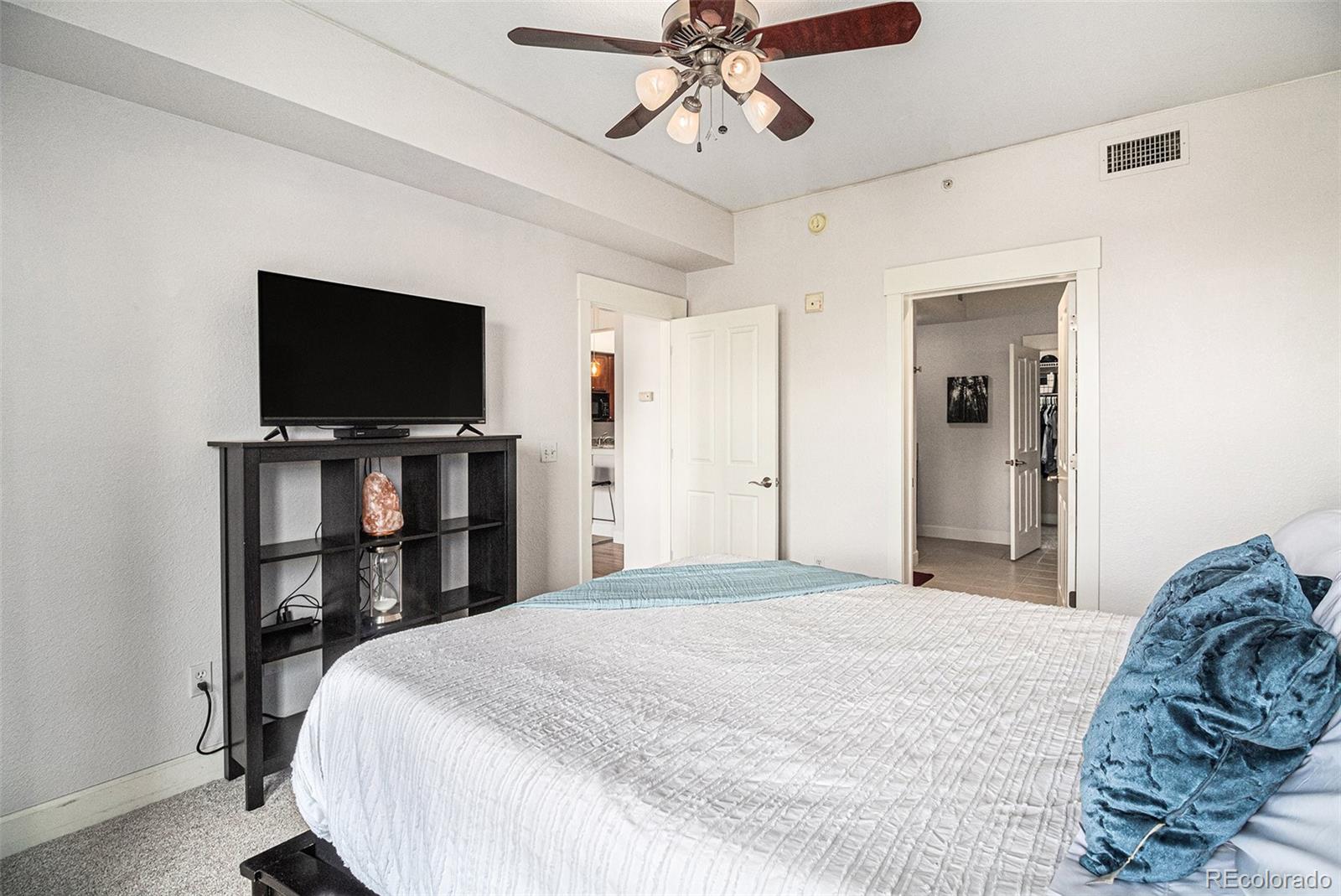 1699 North Downing Street, Unit 302 Denver, CO 80218 - Photo 11 of 23 a bedroom with a bed and a flat screen tv