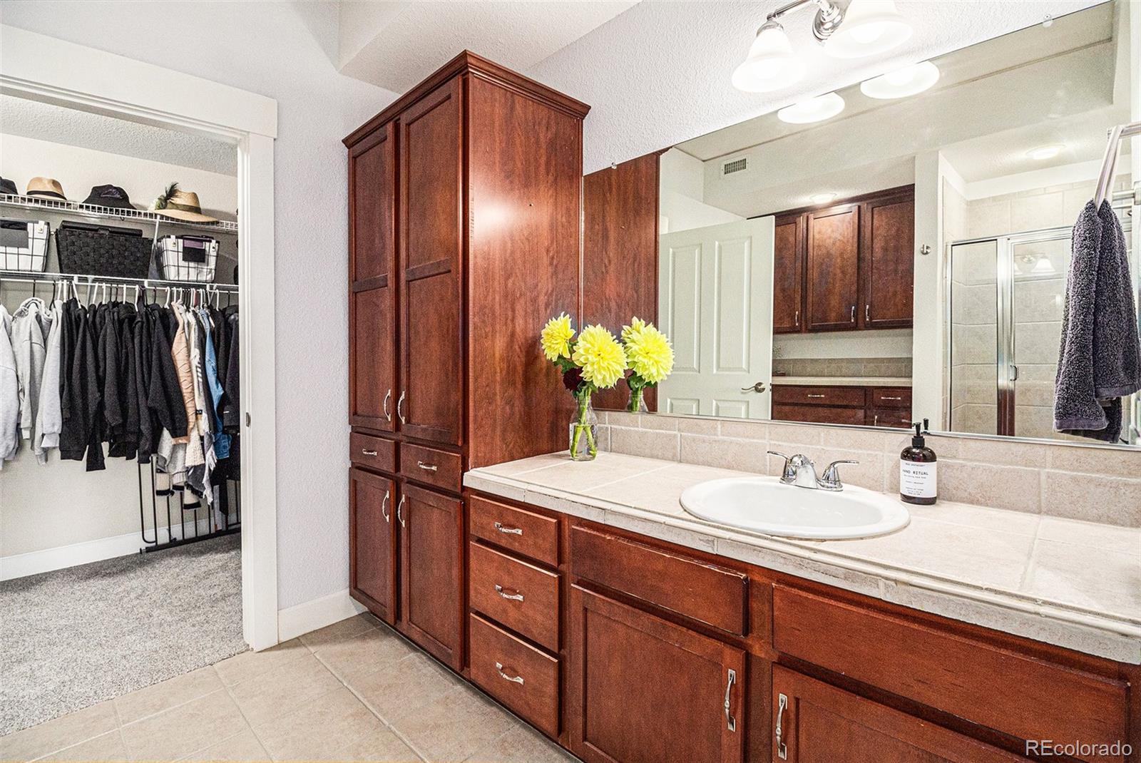 1699 North Downing Street, Unit 302 Denver, CO 80218 - Photo 12 of 23 a bathroom with a sink and a mirror