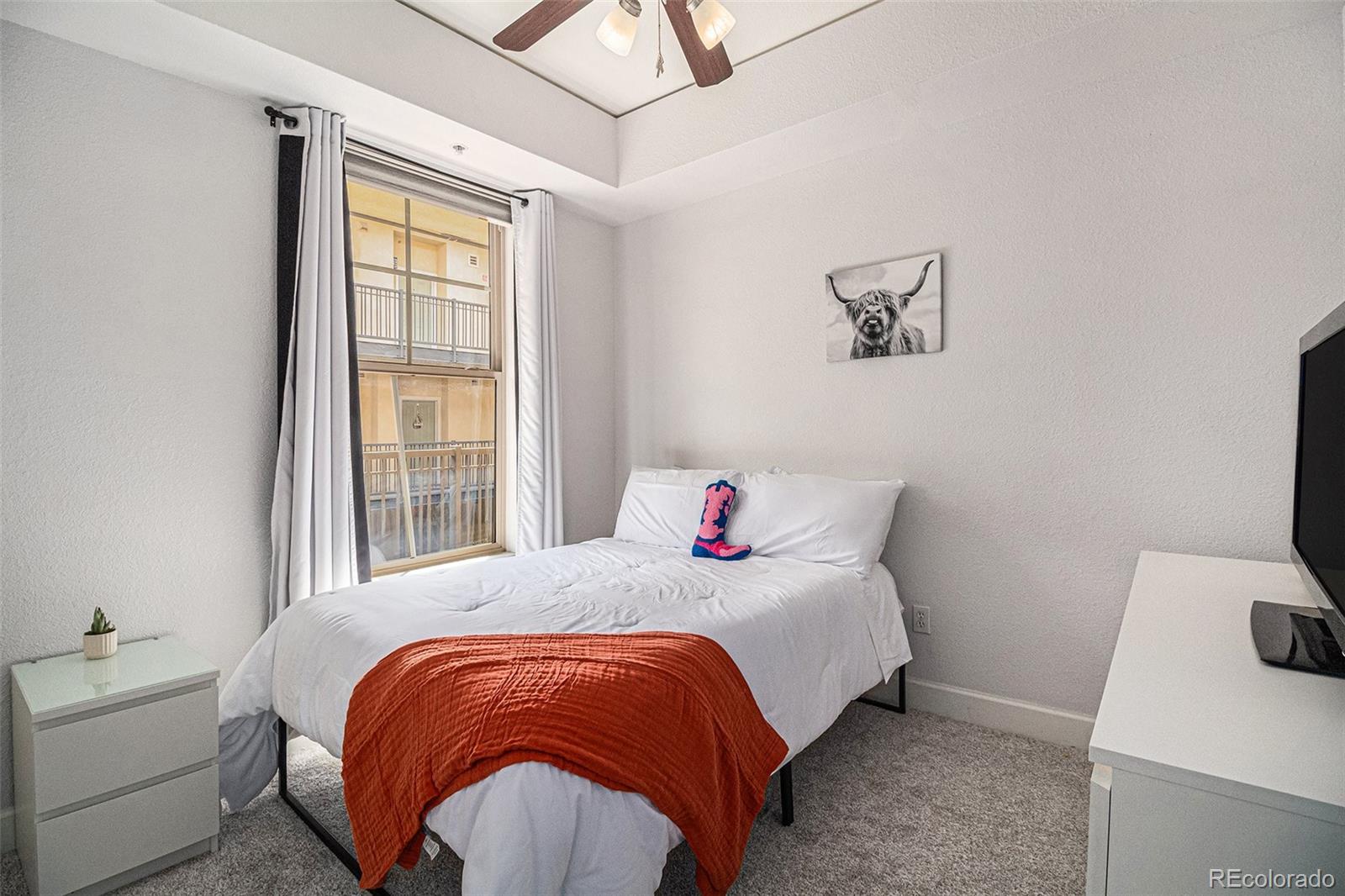 1699 North Downing Street, Unit 302 Denver, CO 80218 - Photo 14 of 23 a bedroom with a bed and a window