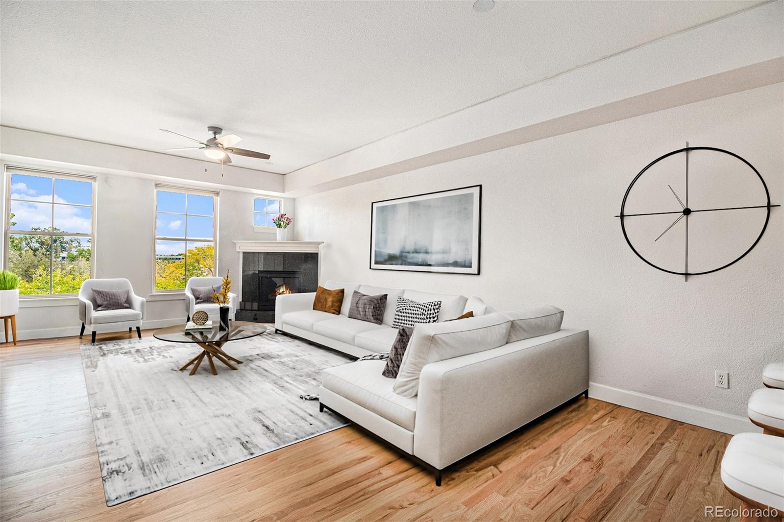 1699 North Downing Street, Unit 302 Denver, CO 80218 - Photo 2 of 23 a living room with furniture a rug and a fireplace