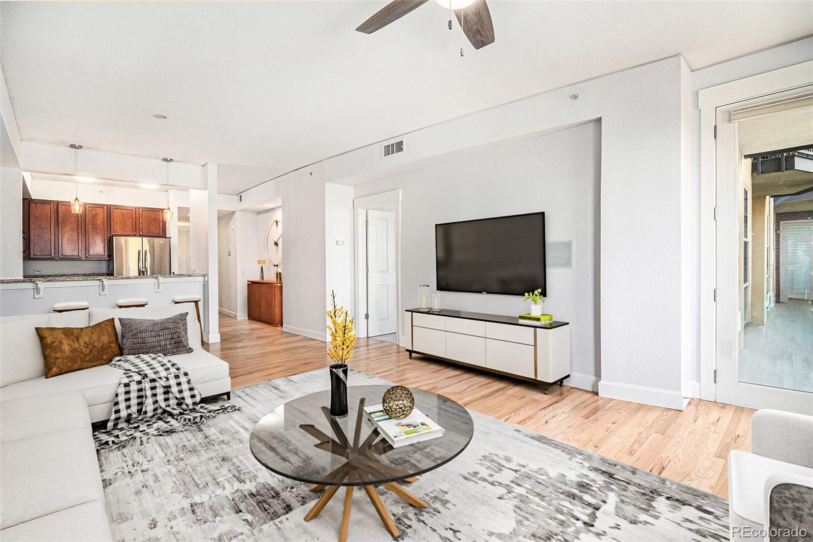 1699 North Downing Street, Unit 302 Denver, CO 80218 - Photo 3 of 23 a living room with furniture and a flat screen tv