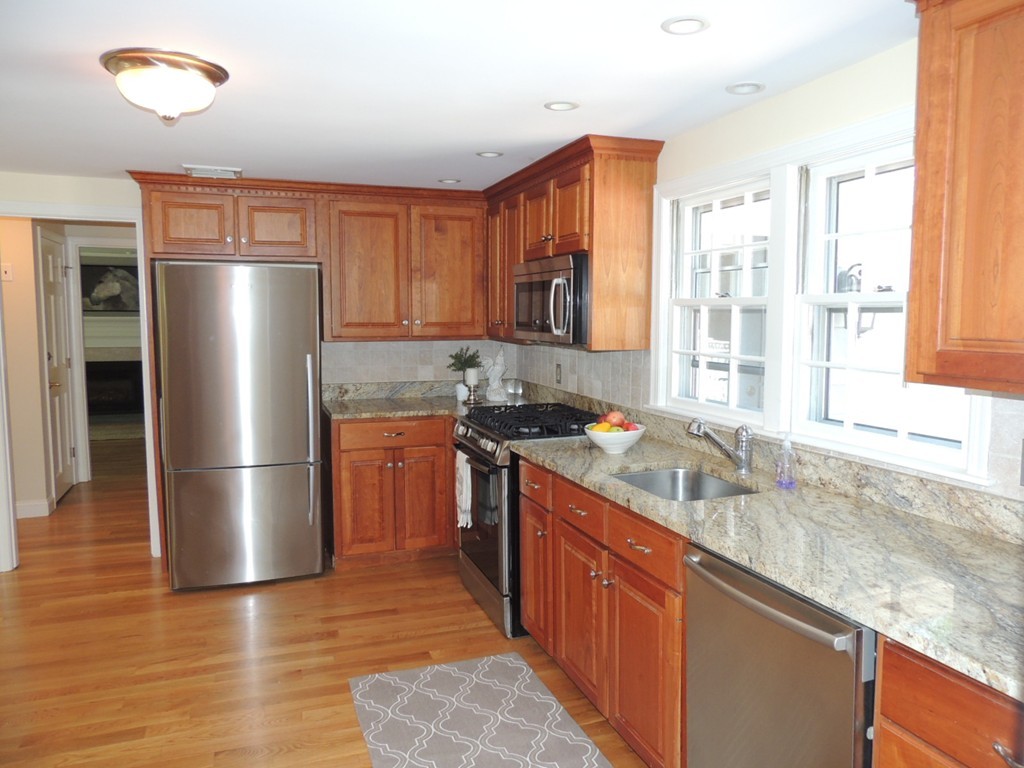 56 Ortins Road Hamilton, MA 01982 - Photo 8 of 30 a kitchen with stainless steel appliances granite countertop a refrigerator a sink a stove and a microwave oven