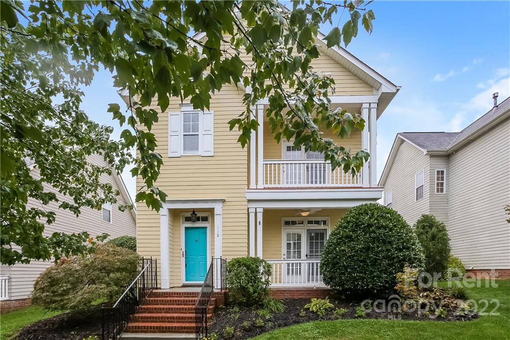 front view of a house with a tree