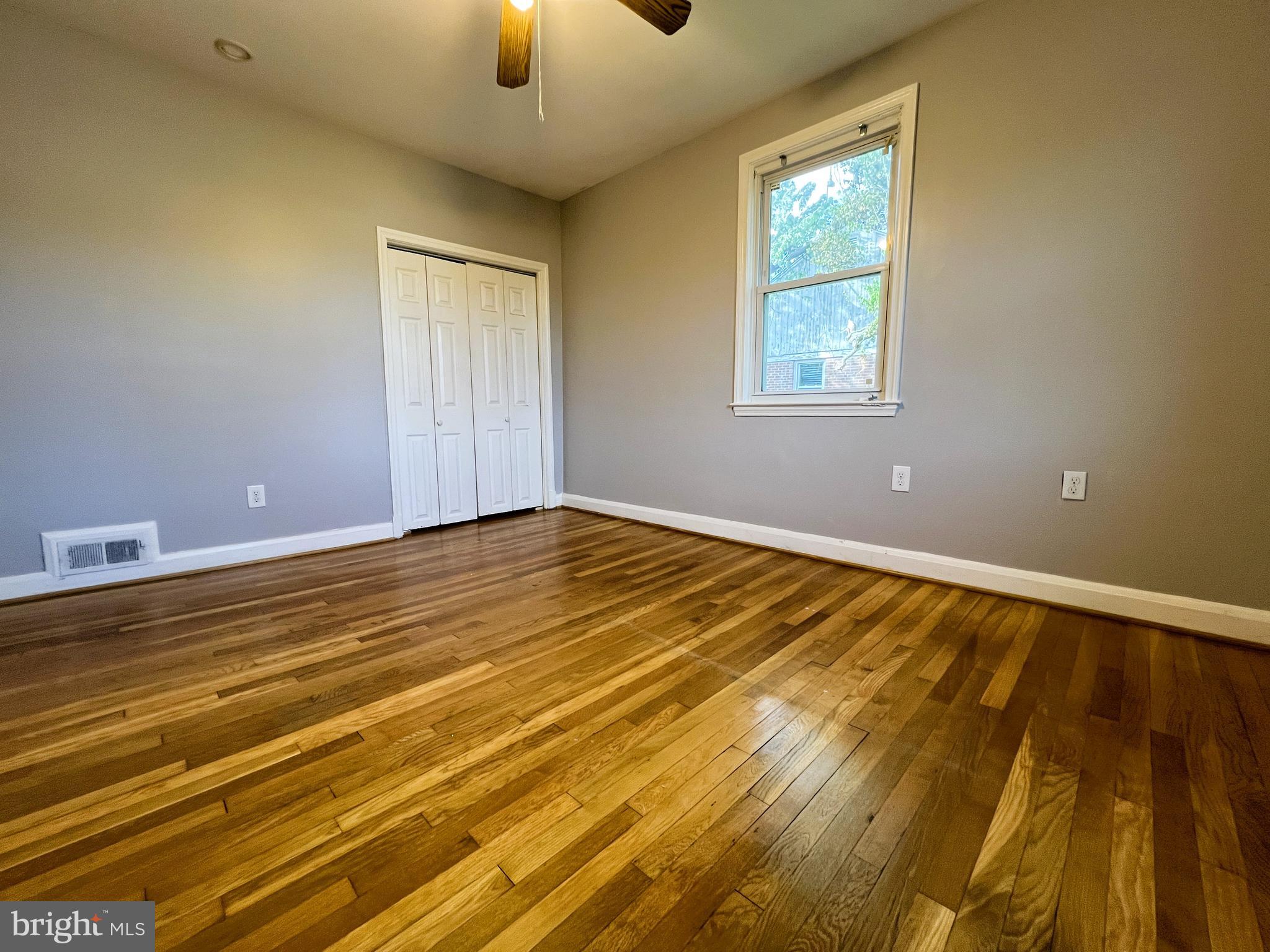 3705 Bancroft Road Baltimore, MD 21215 - Photo 23 of 50 a view of an empty room with window and wooden floor