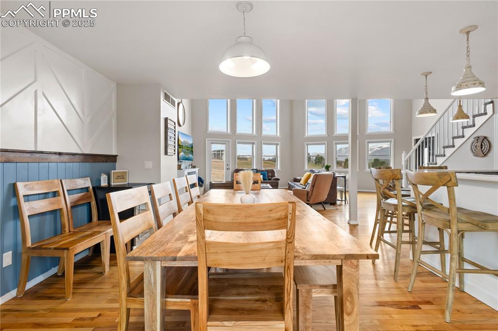 545 Struthers Loop Colorado Springs, CO 80921 - Photo 12 of 48 a view of a dining room with furniture a chandelier and wooden floor