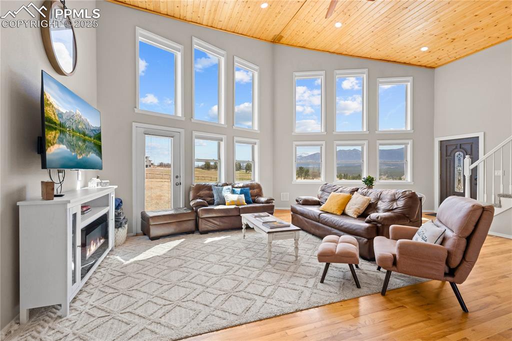 545 Struthers Loop Colorado Springs, CO 80921 - Photo 13 of 48 a living room with furniture a flat screen tv and a floor to ceiling window