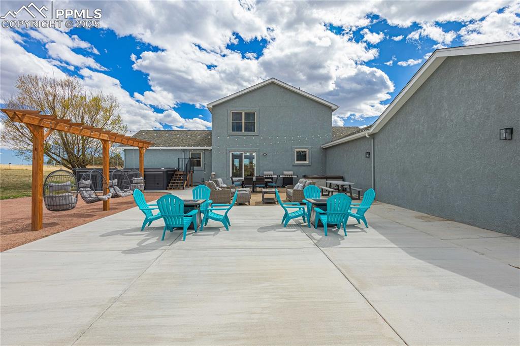 545 Struthers Loop Colorado Springs, CO 80921 - Photo 37 of 48 a view of a patio with couches table and chairs and potted plants