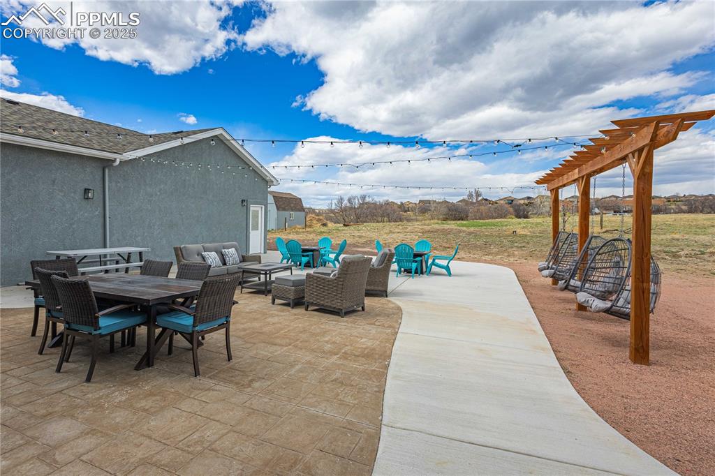 545 Struthers Loop Colorado Springs, CO 80921 - Photo 38 of 48 a view of a terrace with furniture and garden