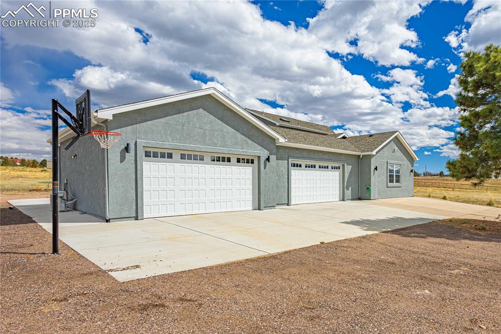 545 Struthers Loop Colorado Springs, CO 80921 - Photo 44 of 48 a view of yellow house with a big yard and a large tree