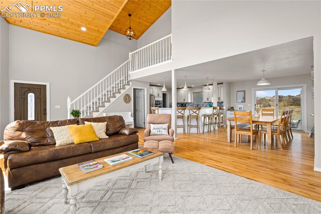 545 Struthers Loop Colorado Springs, CO 80921 - Photo 6 of 48 a living room with furniture and a dining table with wooden floor